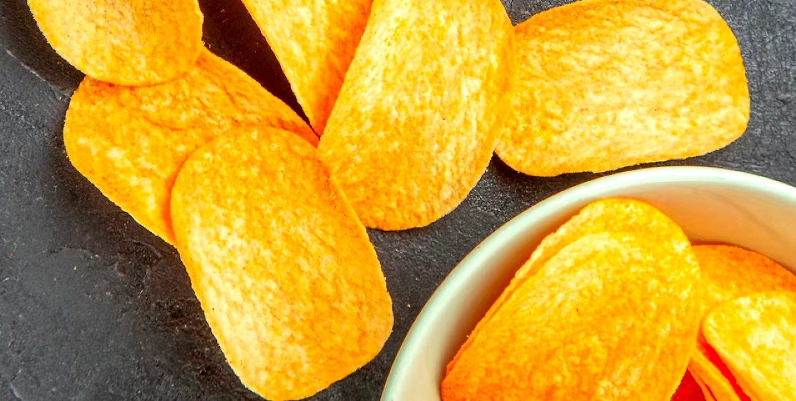 Close-up of seasoned, oval-shaped crispy potato chips.