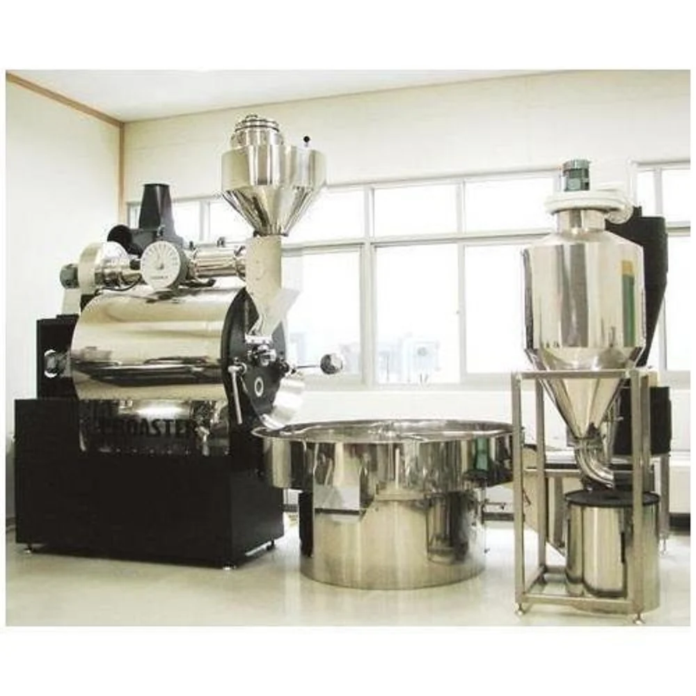 Large industrial stainless steel coffee roaster with cooling tray and cyclone collector.